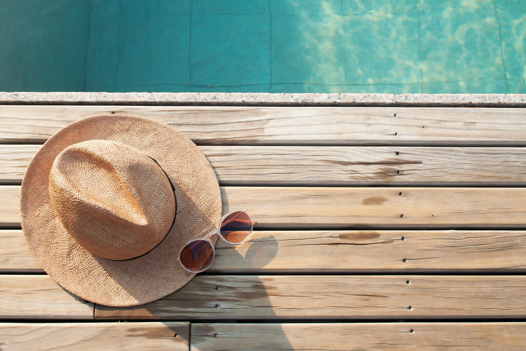 Holiday during lockdown - Hat and glasses on poolside